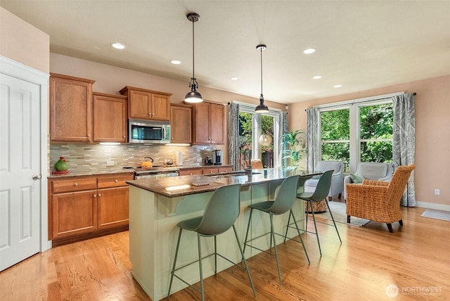 1422 Brighton Way SE, Olympia, WA 98501 - kitchen with appliances with stainless steel finishes, brown cabinets, decorative backsplash, light wood-style floors, and recessed lighting