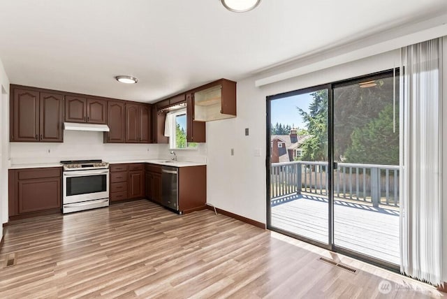 6114 47th Street Ct W, University Place, WA 98466 - kitchen with stainless steel appliances, under cabinet range hood, light wood-type flooring, and healthy amount of natural light