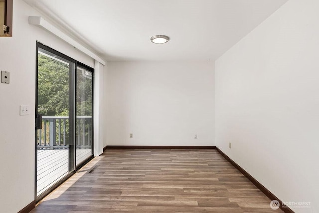 6114 47th Street Ct W, University Place, WA 98466 - unfurnished room featuring wood finished floors and baseboards