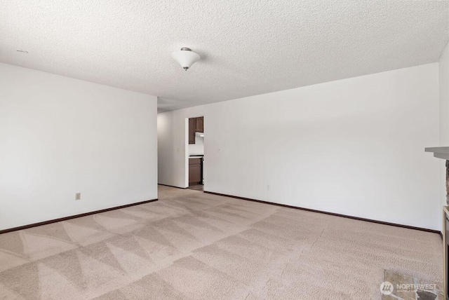 6114 47th Street Ct W, University Place, WA 98466 - unfurnished room featuring light colored carpet and a textured ceiling