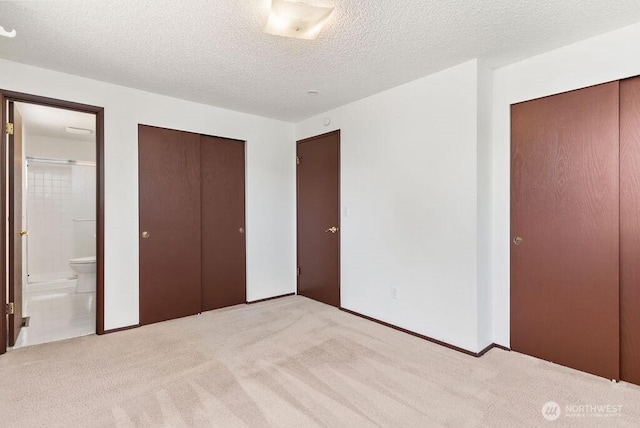 6114 47th Street Ct W, University Place, WA 98466 - unfurnished bedroom with light carpet, a textured ceiling, and ensuite bath