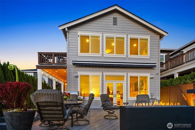 6511 108th Ave NE Unit 3, Kirkland, WA 98033 - rear view of property featuring a fire pit, a wooden deck, outdoor dining area, a balcony, and french doors