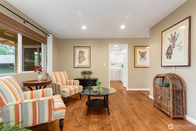 24812 12th Ave S, Des Moines, WA 98198 - sitting room featuring recessed lighting, light wood finished floors, and a textured ceiling