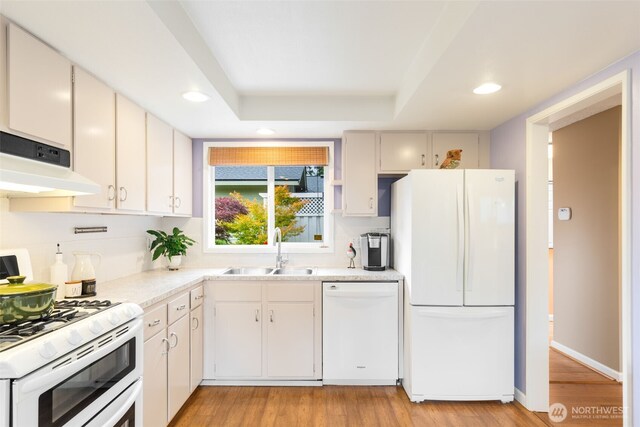 24812 12th Ave S, Des Moines, WA 98198 - kitchen with white appliances, recessed lighting, light countertops, range hood, and light wood finished floors