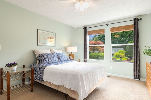 24812 12th Ave S, Des Moines, WA 98198 - bedroom featuring light carpet, a textured ceiling, and a ceiling fan