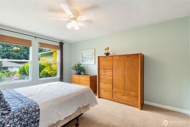 24812 12th Ave S, Des Moines, WA 98198 - bedroom featuring light carpet, a textured ceiling, and ceiling fan