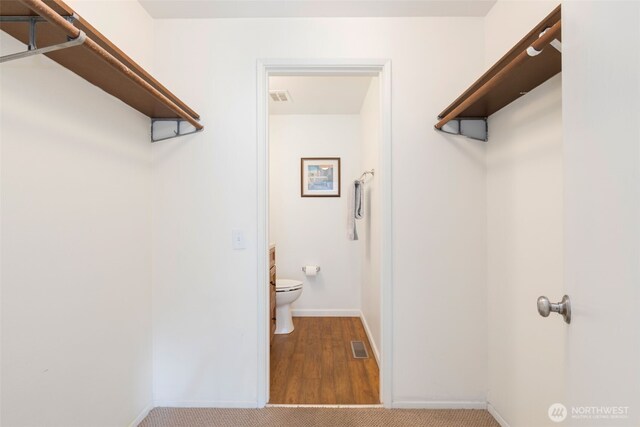 24812 12th Ave S, Des Moines, WA 98198 - walk in closet with wood finished floors and carpet