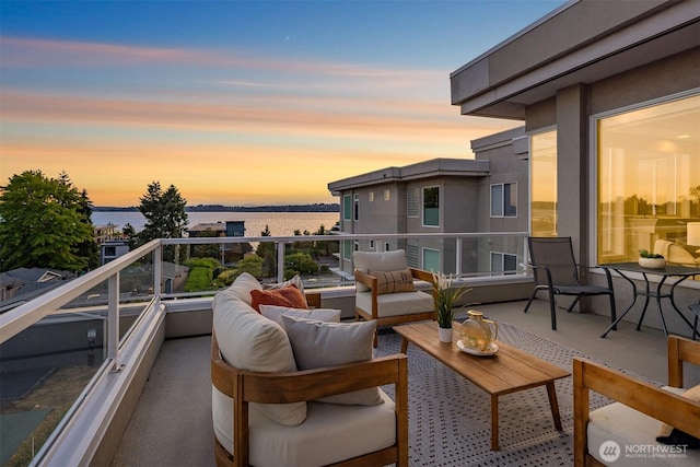6424 Lake Washington Blvd NE Unit 34, Kirkland, WA 98033 - balcony at dusk featuring a water view and an outdoor living space