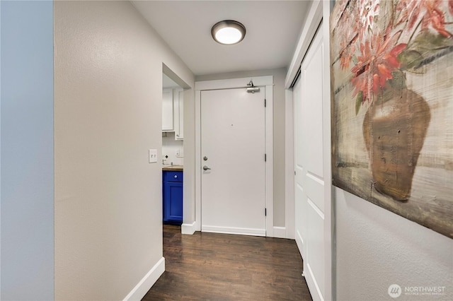 8021 234th St SW Unit 211, Edmonds, WA 98026 - hallway featuring dark wood-style floors and baseboards