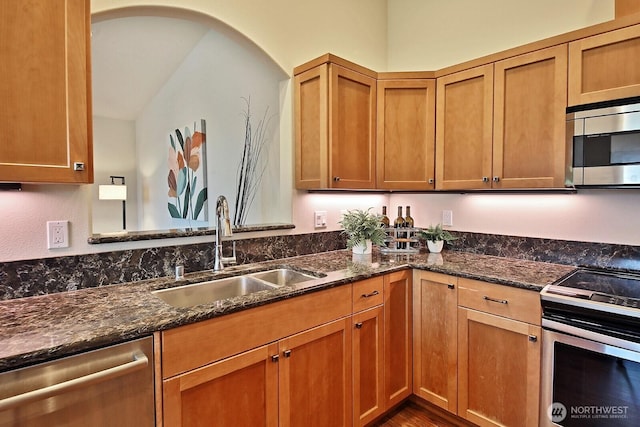 4880 Harbor Hills Dr, Freeland, WA 98249 - kitchen featuring stainless steel appliances, dark stone countertops, brown cabinetry, and wood finished floors