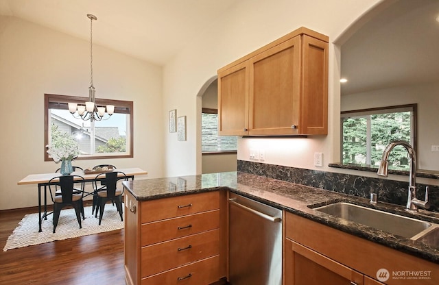 4880 Harbor Hills Dr, Freeland, WA 98249 - kitchen featuring dishwasher, arched walkways, dark stone countertops, dark wood finished floors, and vaulted ceiling
