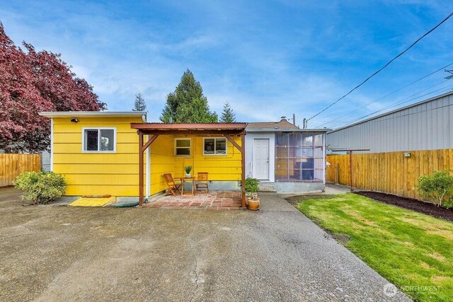 811 E 60th St, Tacoma, WA 98404 - back of property featuring a patio area