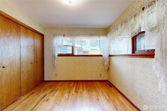2004 Lark Dr, Walla Walla, WA 99362 - unfurnished bedroom with wallpapered walls, hardwood / wood-style floors, and a closet
