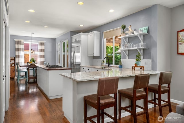 5625 Elizabeth Ave SE, Auburn, WA 98092 - kitchen with appliances with stainless steel finishes, a peninsula, a center island, recessed lighting, and dark wood-style floors