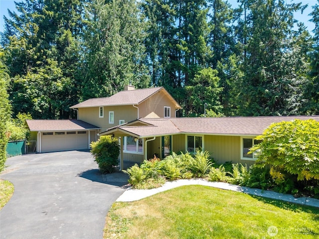 6426 Zangle Rd NE, Olympia, WA 98506 - view of front of property with driveway, a front yard, a chimney, and an attached garage