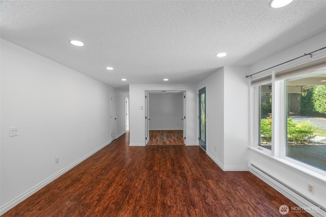 6426 Zangle Rd NE, Olympia, WA 98506 - spare room with a baseboard heating unit, recessed lighting, a textured ceiling, and wood finished floors