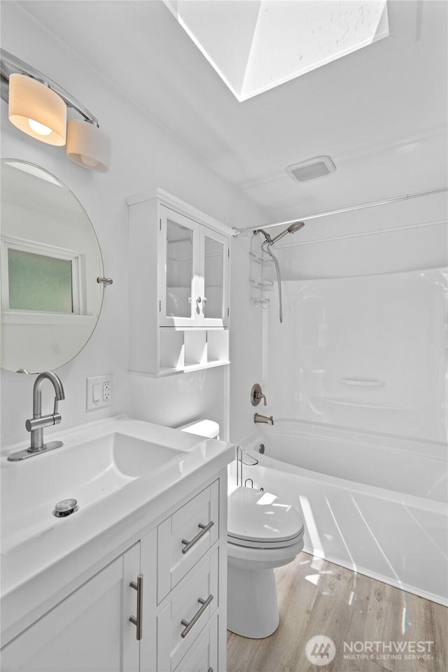 6426 Zangle Rd NE, Olympia, WA 98506 - bathroom featuring vanity, shower / tub combination, and wood finished floors