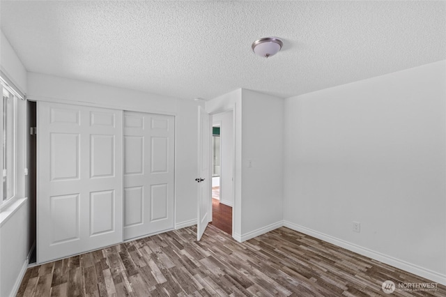6426 Zangle Rd NE, Olympia, WA 98506 - unfurnished bedroom featuring wood finished floors, a closet, and a textured ceiling