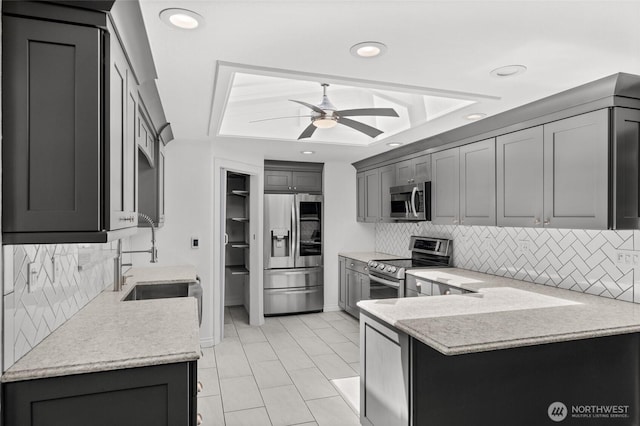 6426 Zangle Rd NE, Olympia, WA 98506 - kitchen featuring stainless steel appliances, ceiling fan, decorative backsplash, a peninsula, and recessed lighting