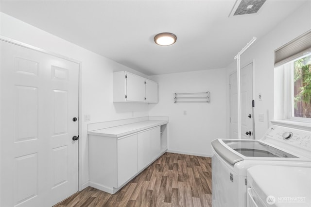 6426 Zangle Rd NE, Olympia, WA 98506 - washroom featuring washing machine and dryer, cabinet space, and dark wood-type flooring