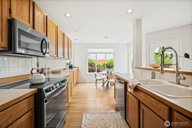 18353 160th Pl SE, Renton, WA 98058 - kitchen featuring appliances with stainless steel finishes, plenty of natural light, recessed lighting, light wood finished floors, and brown cabinets