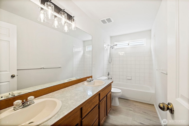 18353 160th Pl SE, Renton, WA 98058 - full bath with double vanity, wood finished floors, and shower / bathtub combination