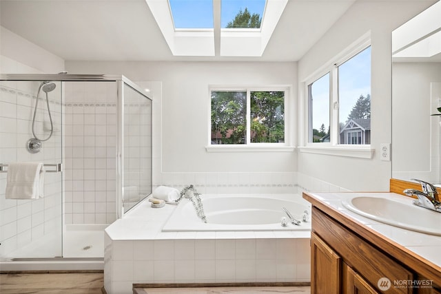 18353 160th Pl SE, Renton, WA 98058 - bathroom featuring a bath, a shower stall, vanity, and a skylight
