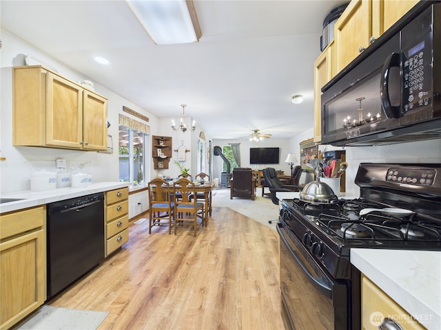 27014 80th St E, Buckley, WA 98321 - kitchen featuring black appliances, a chandelier, light countertops, and a ceiling fan