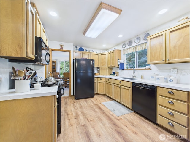 27014 80th St E, Buckley, WA 98321 - kitchen with black appliances, light wood finished floors, healthy amount of natural light, light countertops, and recessed lighting