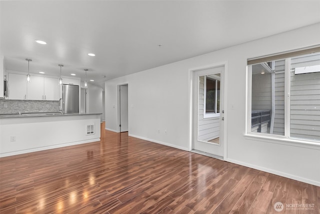232 Belmont Ave E # 201, Seattle, WA 98102 - unfurnished living room featuring recessed lighting, dark wood-style floors, and plenty of natural light