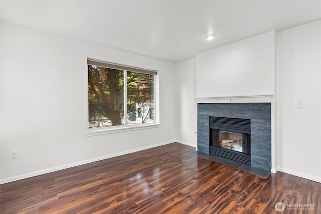 232 Belmont Ave E # 201, Seattle, WA 98102 - unfurnished living room featuring a tiled fireplace and wood finished floors