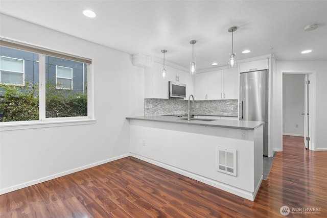 232 Belmont Ave E # 201, Seattle, WA 98102 - kitchen featuring stainless steel appliances, a peninsula, white cabinetry, tasteful backsplash, and recessed lighting