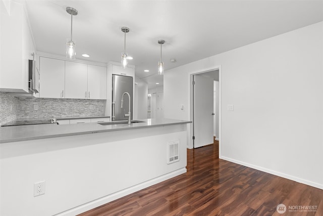 232 Belmont Ave E # 201, Seattle, WA 98102 - kitchen with recessed lighting, white cabinets, tasteful backsplash, light countertops, and dark wood-style floors
