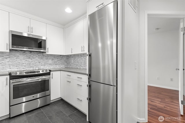 232 Belmont Ave E # 201, Seattle, WA 98102 - kitchen with appliances with stainless steel finishes, white cabinetry, decorative backsplash, recessed lighting, and dark tile patterned floors