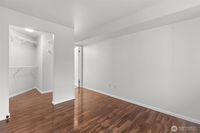 232 Belmont Ave E # 201, Seattle, WA 98102 - unfurnished bedroom with dark wood-style flooring and a walk in closet