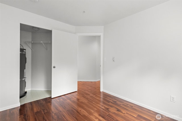 232 Belmont Ave E # 201, Seattle, WA 98102 - unfurnished bedroom with wood finished floors, a closet, and strapped water heater