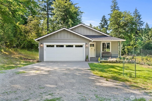 5843 Octave Ct SE, Olympia, WA 98513 - view of front of house featuring concrete driveway, a front lawn, a garage, covered porch, and board and batten siding