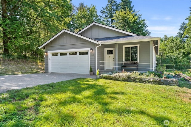 5843 Octave Ct SE, Olympia, WA 98513 - view of front of property with driveway, an attached garage, a front lawn, covered porch, and board and batten siding