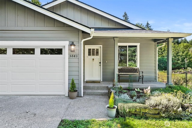 5843 Octave Ct SE, Olympia, WA 98513 - view of exterior entry featuring a garage, covered porch, and board and batten siding