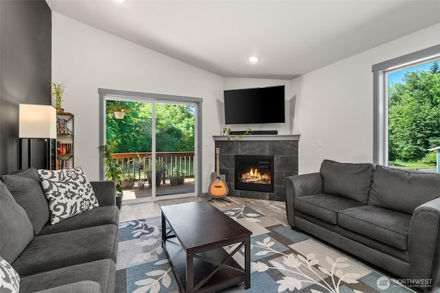 5843 Octave Ct SE, Olympia, WA 98513 - living area featuring healthy amount of natural light, a tiled fireplace, wood finished floors, recessed lighting, and lofted ceiling