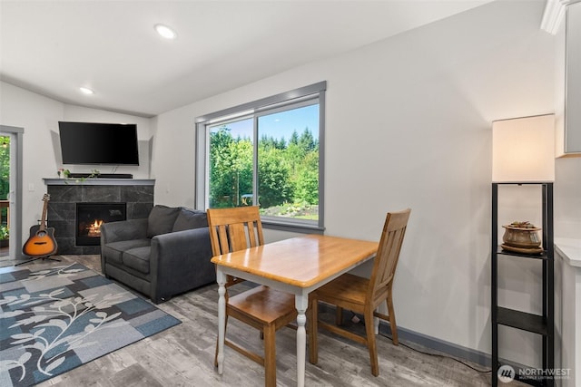 5843 Octave Ct SE, Olympia, WA 98513 - dining area with light wood-type flooring, a tiled fireplace, lofted ceiling, and recessed lighting