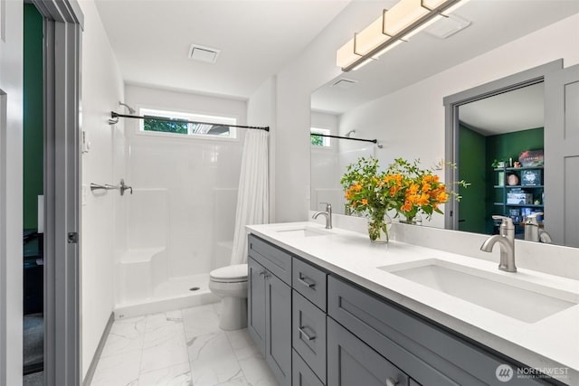 5843 Octave Ct SE, Olympia, WA 98513 - full bathroom featuring double vanity, a shower with shower curtain, and marble look tiles