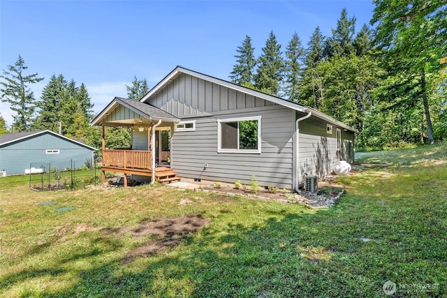 5843 Octave Ct SE, Olympia, WA 98513 - view of front of property featuring a wooden deck, board and batten siding, a front lawn, and crawl space