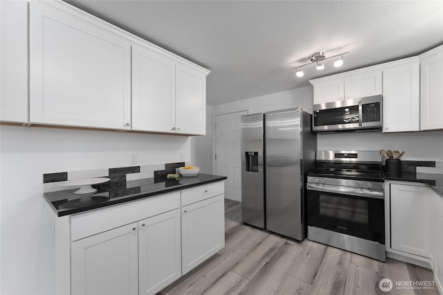2112 S Crestmont Dr, Moses Lake, WA 98837 - kitchen with stainless steel appliances, light wood finished floors, and white cabinetry