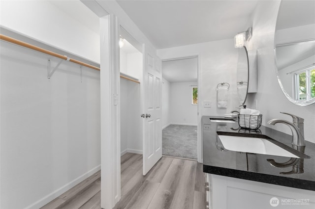 2112 S Crestmont Dr, Moses Lake, WA 98837 - bathroom with wood finished floors, double vanity, and a spacious closet