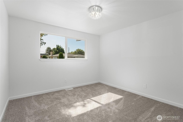 2112 S Crestmont Dr, Moses Lake, WA 98837 - carpeted spare room featuring baseboards and a chandelier