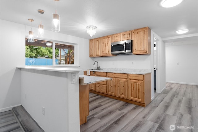 2112 S Crestmont Dr, Moses Lake, WA 98837 - kitchen featuring stainless steel microwave, light countertops, and light wood-style flooring