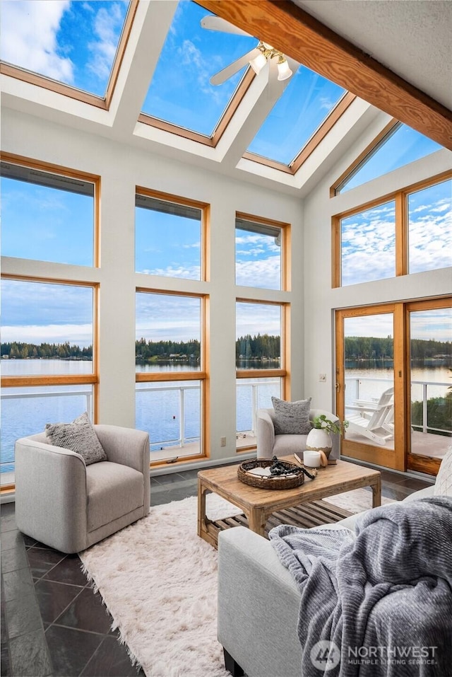 2210 E Mason Lake Dr W, Grapeview, WA 98546 - living area featuring a skylight, a water view, ceiling fan, beam ceiling, and high vaulted ceiling