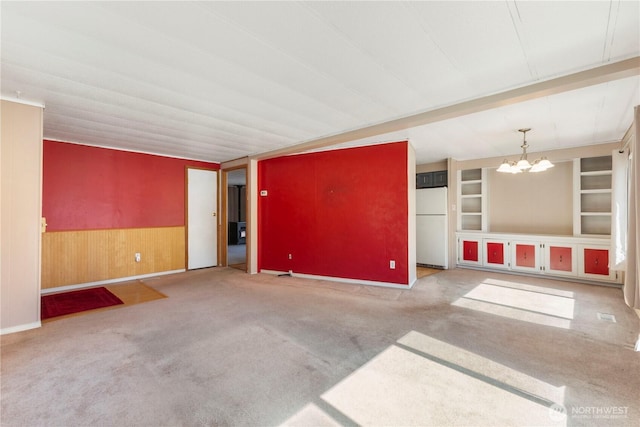 7138 Englewood Dr SE Unit 32, Olympia, WA 98513 - spare room with carpet, a chandelier, wood walls, and a wainscoted wall