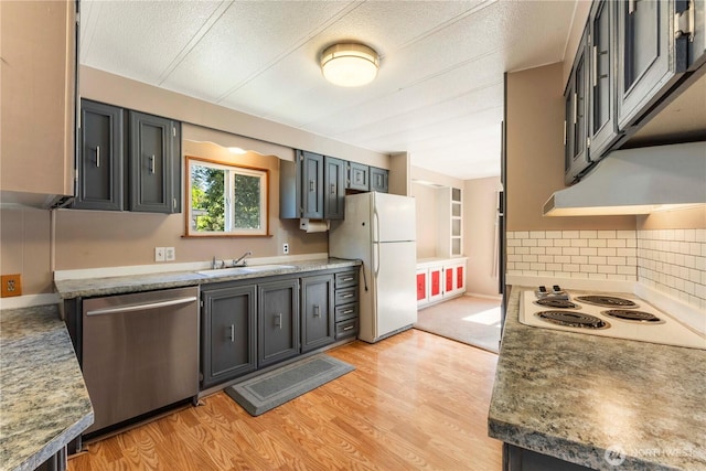 7138 Englewood Dr SE Unit 32, Olympia, WA 98513 - kitchen with white appliances, light wood finished floors, decorative backsplash, under cabinet range hood, and a textured ceiling
